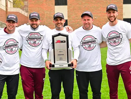 Carlo Acquista with the Fordham coaching staff and trophy