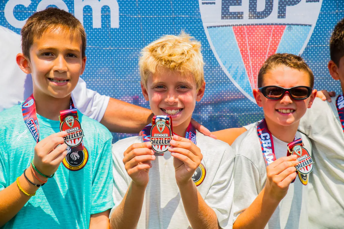 Summer Select players showing their tournament medals